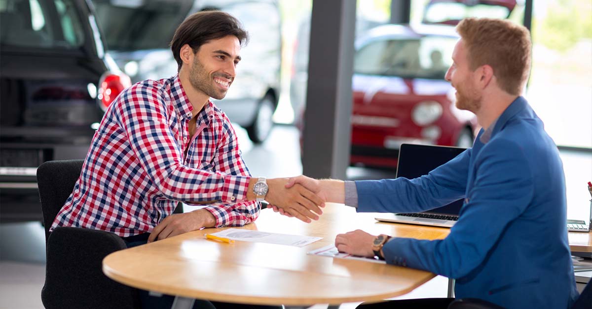 Image-of-a-man-at-a-car-dealership-purchasing-a-vehicle