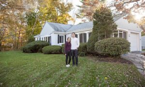 Image-of-a-young-couple-in-front-of-their-first-home
