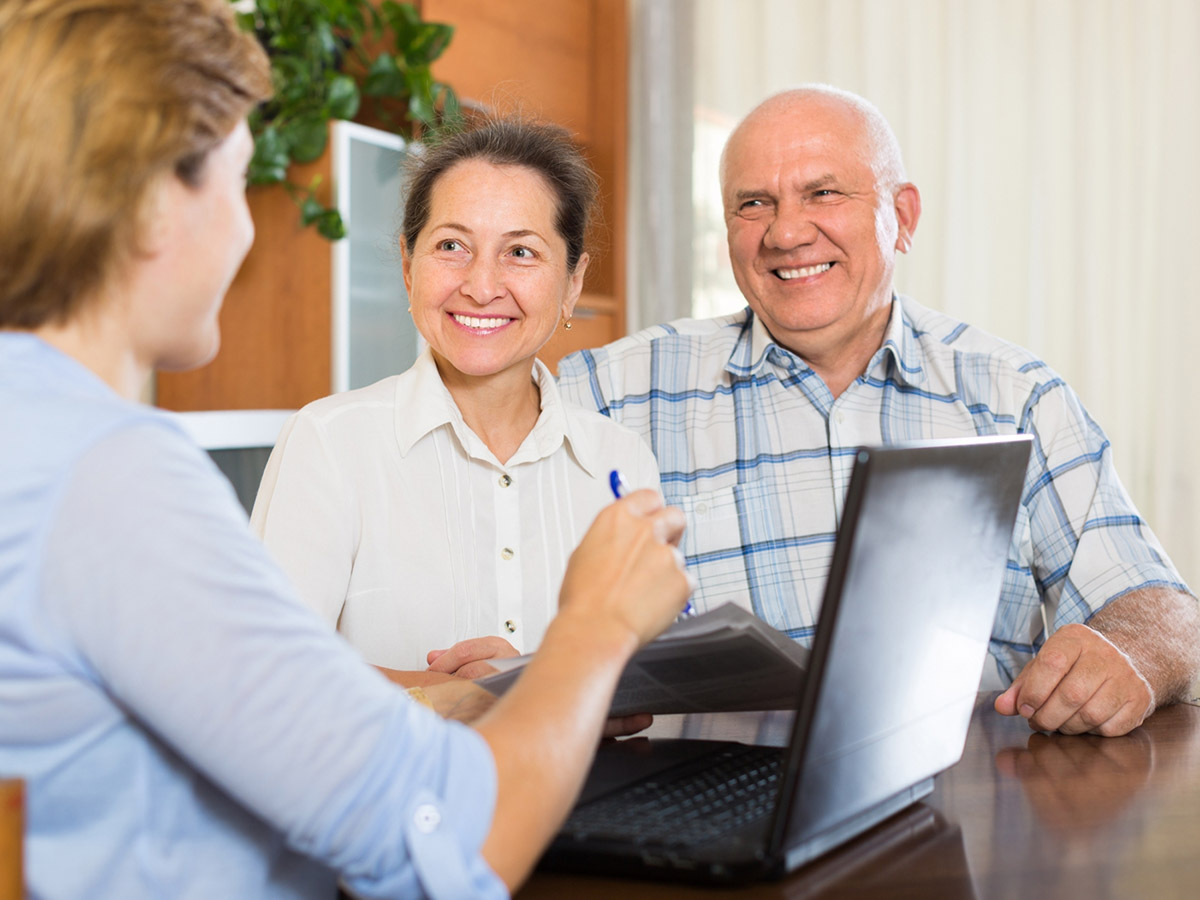Older couple talking with a consultant