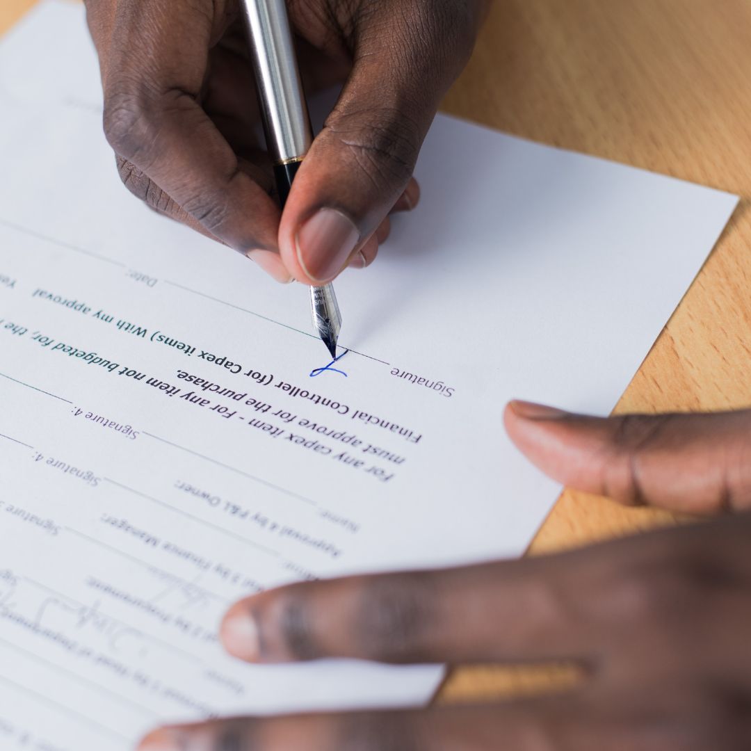 person signing a document