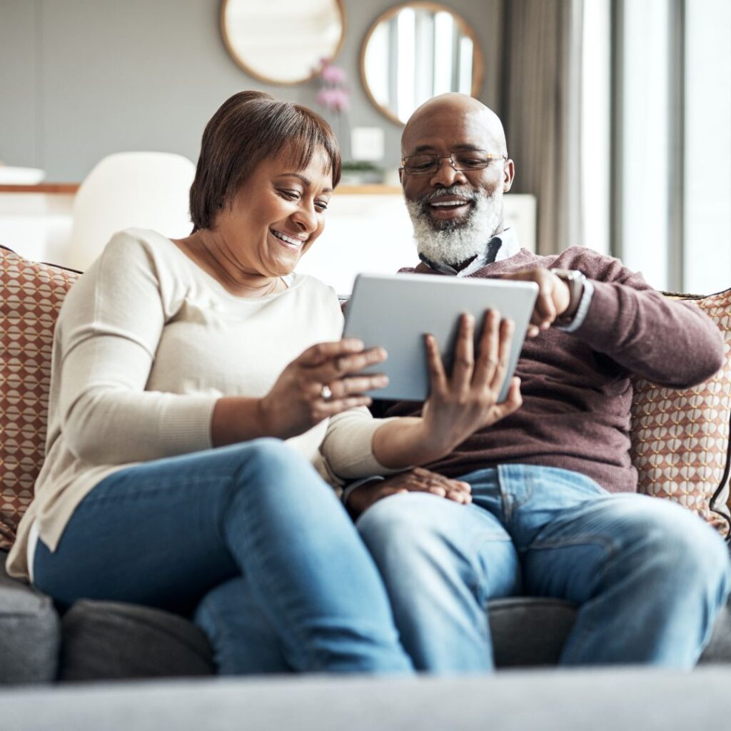 smiling older couple on couch