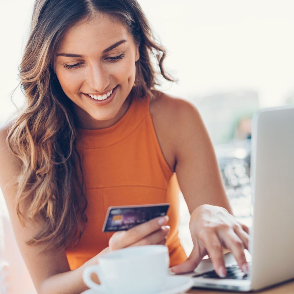 Women smiling buying something with credit card