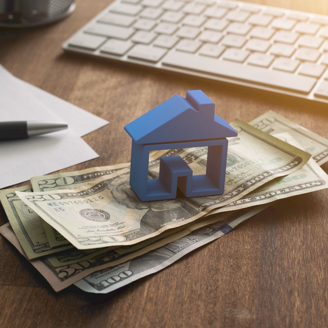Small model house on top of cash