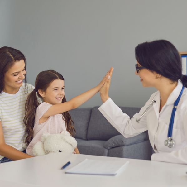 A doctor giving a child a high five